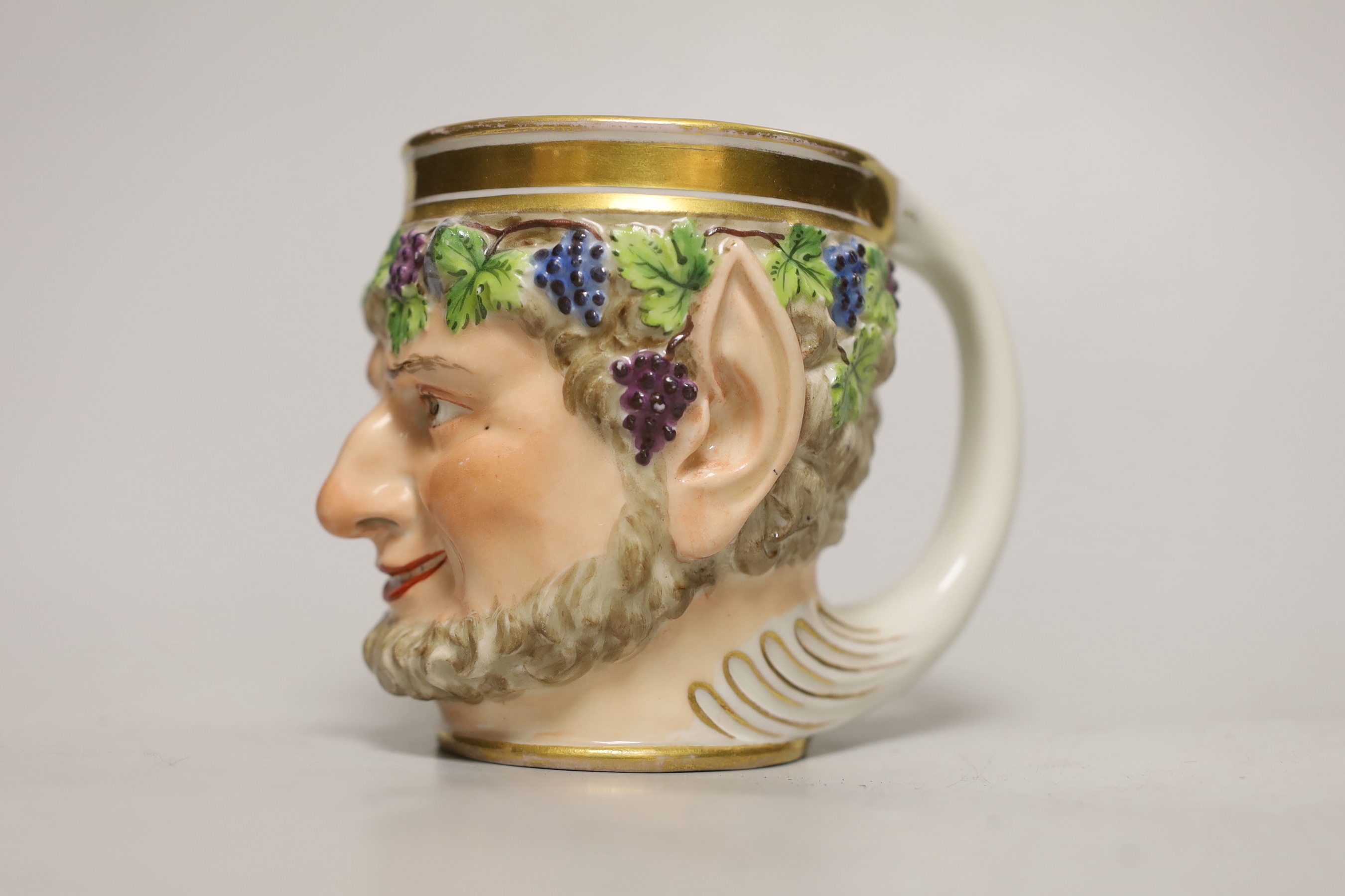 A Vienna porcelain satyr cup, impressed number 827, possibly for the date 1827, 10cm high